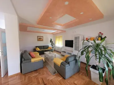 a living room with two couches and a tv at Stan Ledine in Ledine