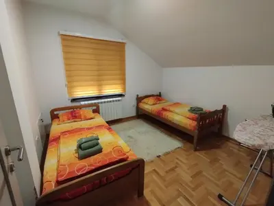 a small room with two beds and a window at Stan Ledine in Ledine