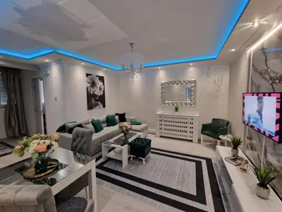 a living room with a couch and a tv at AT Mirror in Voždovac