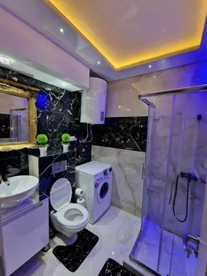 a bathroom with a toilet and a shower and a sink at AT Mirror in Voždovac
