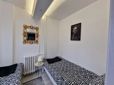 a bedroom with two beds and a mirror on the wall at AT Mirror in Voždovac