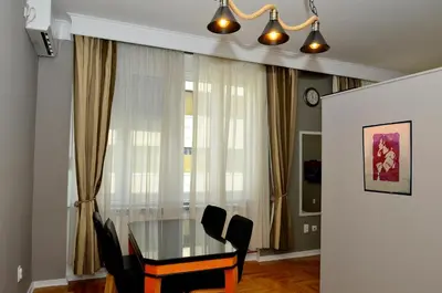 a dining room with a glass table and black chairs at Kursula in Vračar (historical)