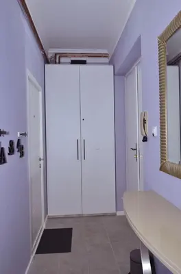a large white closet in a room with a table at Kursula in Vračar (historical)