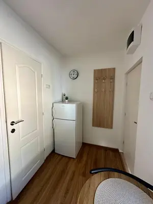 a white room with a refrigerator and a door at The Old Town House in Belgrade