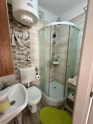 a bathroom with a shower and a toilet and a sink at The Old Town House in Belgrade