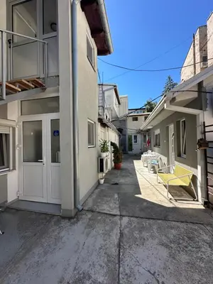 an empty alley between two buildings with a yellow bench at The Old Town House in Belgrade