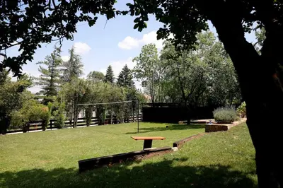 a park with a picnic table in the grass at Vila Ruža Vetra in Belgrade