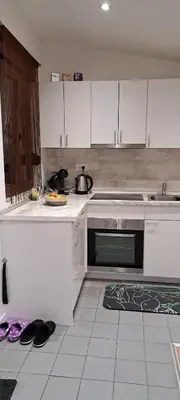 a kitchen with white cabinets and a stove top oven at SAMITEST in Batajnica