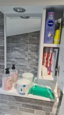 a shelf in a bathroom with items on it at SAMITEST in Batajnica