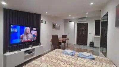 a room with a bed with a flat screen tv at SAMITEST in Batajnica