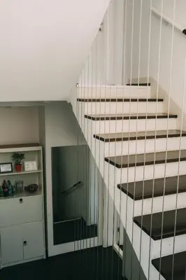 a white staircase in a room with a kitchen at Smart hostel in Belgrade