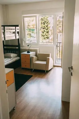 a living room with a couch and a chair at Smart hostel in Belgrade