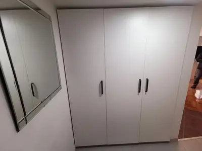 a bathroom with white cabinets and a mirror at Nov apartman u mirnoj ulici u centru Beograda in Belgrade