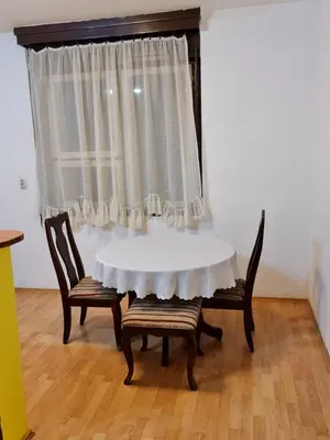 a white table with two chairs and a window at Maksim in Vračar (historical)