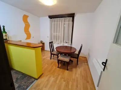 a kitchen with a table and chairs in a room at Maksim in Vračar (historical)