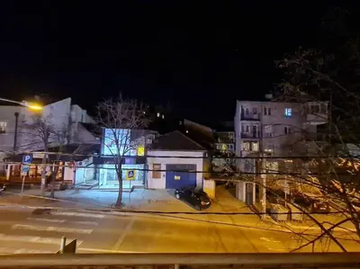 a city street at night with a street light and buildings at Maksim in Vračar (historical)