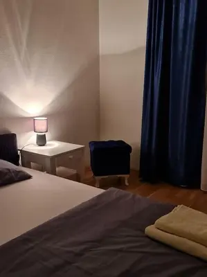 a bedroom with a bed and a desk with a lamp at Maksim in Vračar (historical)