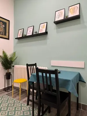 a dining room with a table and two chairs at So Cozy in Belgrade