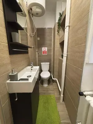a small bathroom with a sink and a toilet at So Cozy in Belgrade