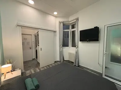 a room with a tv on the wall at So Cozy in Belgrade