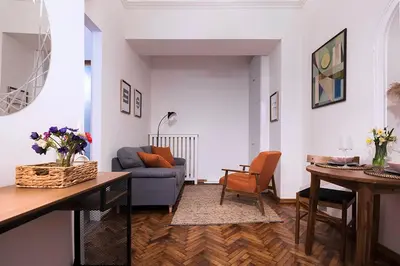 a living room with a blue couch and a table at High Note Apartment in Belgrade