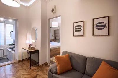a living room with a couch and a bedroom at High Note Apartment in Belgrade
