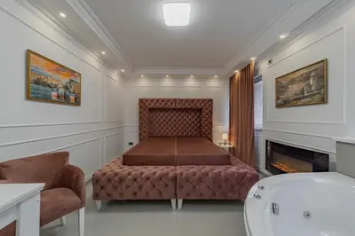 a bathroom with a bench and a fireplace at TIMS Apartman 7 in Belgrade
