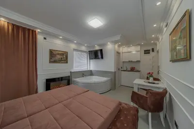 a bedroom with a bed and a bathroom with a tub at TIMS Apartman 7 in Belgrade