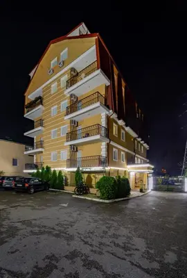 a large apartment building at night with a parking lot at TIMS Apartman 7 in Belgrade