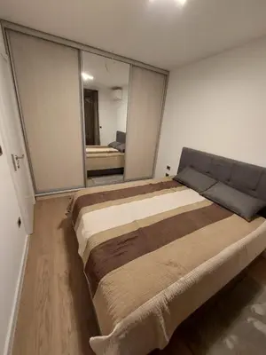 a large bed in a room with a large mirror at Apartment West 65 in Belgrade
