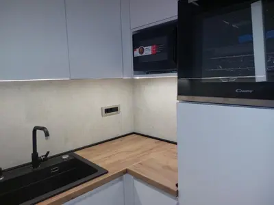 a kitchen with a sink and a refrigerator at Apartment West 65 in Belgrade