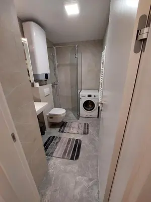 a small bathroom with a toilet and a shower at Apartment West 65 in Belgrade