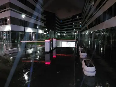 a large building with a lot of windows and a lit up at Apartment West 65 in Belgrade