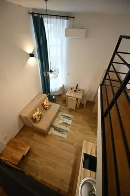 a living room with a couch and a table at BEL GALLERIES ( Karadjordjeva street ) in Sajmište