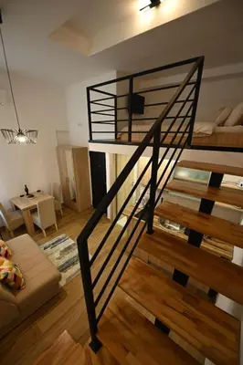 a spiral staircase in a room with a living room at BEL GALLERIES ( Karadjordjeva street ) in Sajmište