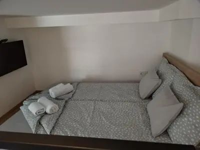 a bed in a room with two pillows on it at BEL GALLERIES ( Karadjordjeva street ) in Sajmište