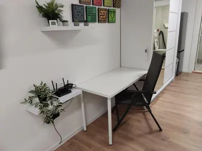 a white desk and a chair in a room at Zarkovo in Belgrade