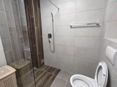 a bathroom with a shower with a toilet and a glass shower stall at Zarkovo in Belgrade