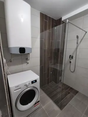 a bathroom with a washing machine and a shower at Zarkovo in Belgrade
