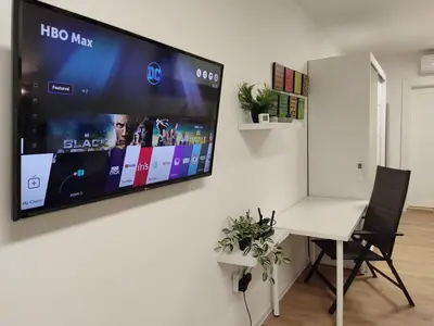 a flat screen tv hanging on a wall in a room at Zarkovo in Belgrade