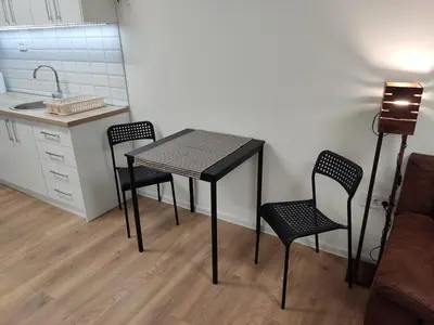 a small kitchen with a table and two chairs at Zarkovo in Belgrade