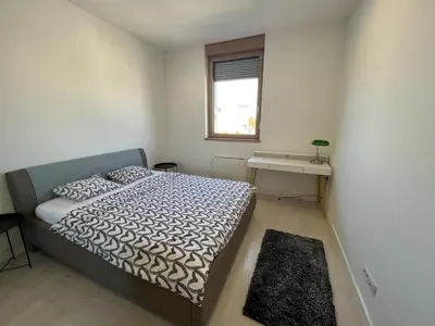 a small bedroom with a bed and a window at Belgrade Center Apartment Lux IV in Belgrade