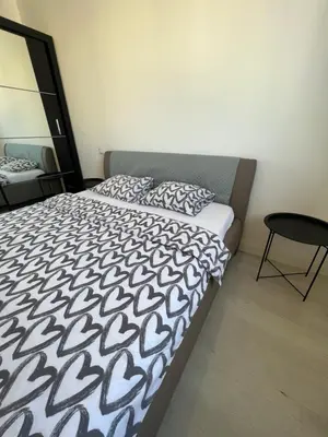 a bedroom with a bed with a black and white comforter at Belgrade Center Apartment Lux IV in Belgrade
