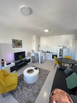 a large living room with a table and yellow chairs at Belgrade Center Apartment Lux IV in Belgrade