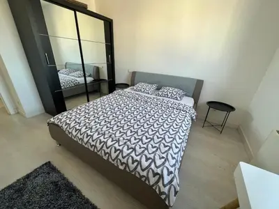 a bedroom with a bed and a large mirror at Belgrade Center Apartment Lux IV in Belgrade