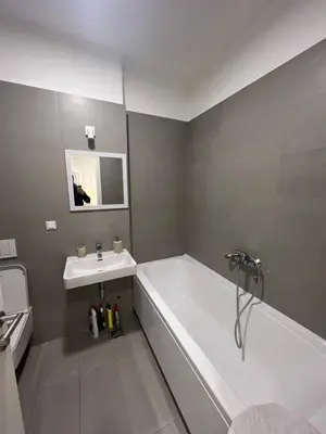 a bathroom with a white tub and a sink at Belgrade Center Apartment Lux IV in Belgrade