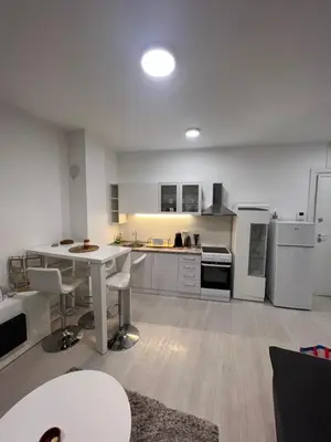 a large kitchen with a white table and chairs at Belgrade Center Apartment Lux IV in Belgrade