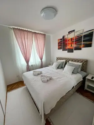 a bedroom with a large bed with towels on it at Elegant escape in Bele Vode