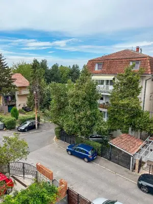 a blue car parked on a street next to a building at Elegant escape in Bele Vode