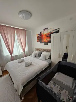 a bedroom with a large bed and a couch at Elegant escape in Bele Vode